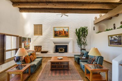 Living Room with Two-story Adobe Wall and Fireplace