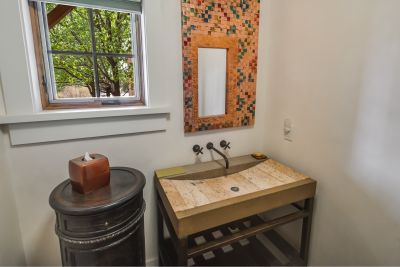 Powder Room  - Iron vanity with custom stone sink; woven metal art piece with vanity mirror inset; 