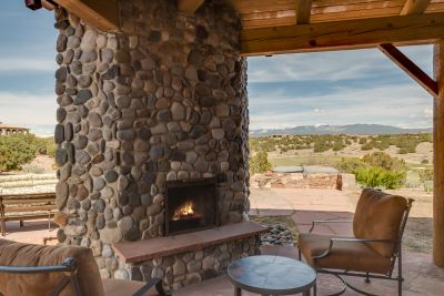 Grand & Dining Portal Corner Fireplace - Looking Out to the Jacuzzi Spa, and Fairway & Sangre de Cristo Mountain Views.  