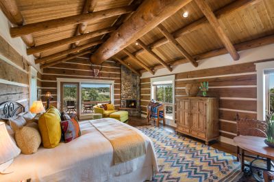 Guest Casita - Split Log Walls, Pitched Ceiling with Massive Center Beam; River Stone Fireplace, Door to Private Patio, Beautiful Mountain Views.