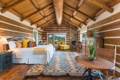 Guest Casita - Split Log Walls, Pitched Ceiling with Massive Center Beam; River Stone Fireplace, Door to Private Patio, Beautiful Mountain Views.