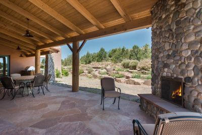 Dining Portal - Accessed off the Kitchen & the Grand Portal - Viking Grill, Fireplace,  Adjacent Landscaping with Native Plantings, Pinon Trees &  Boulders.