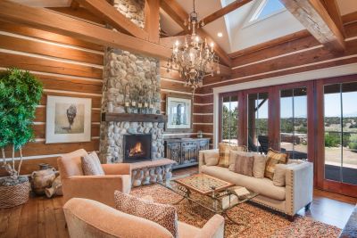 Family/Media  Room - 15' Pitched Beam & Trestle Ceiling, River Rock Fireplace, and French Doors to the Grand Portal; Sangre de Cristo Mountains & Fairway Views.