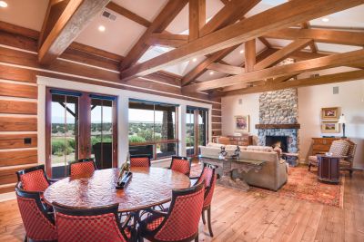 Great Room - Magnificent 15' Pitched Beam & Trestle Ceiling, River Rock Fireplace, Planked Wood Floors, Banks of French Doors to the Grand Portal, Breathtaking Fairway & Sangre de Cristo Views
