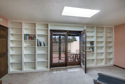 Book shelves in Den / Multipurpose looking out on Back Yard and Portal