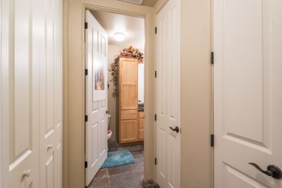 Hallway from entry foyer to bathroom with expanded closets