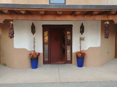 Gracious front entry with classic two tone stucco and covered portal