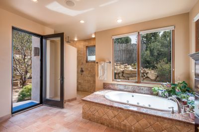 Master Bath - Deep jetted tub with casement windows. Large shower & door to walled flagstone terrace.
