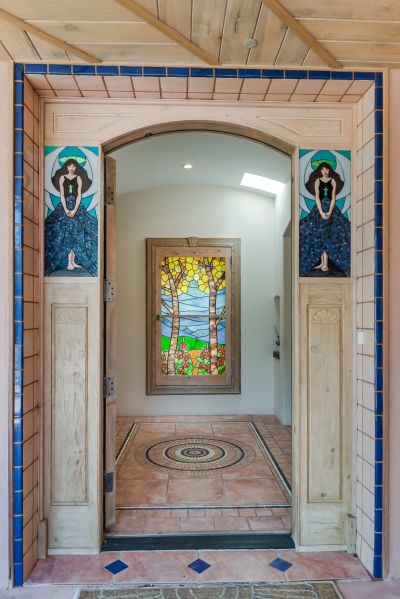 Front door is flanked by handmade art stained glass.