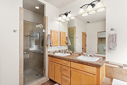 Double sinks in primary bath with a walk-in shower