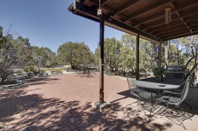 Private, wooded back patio perfect for quiet relaxation or entertaining.