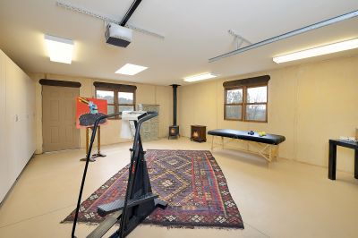 Separate 450 sq. ft. studio / exercise room / man cave with wood burning fireplace.  Easy to convert to a third garage 