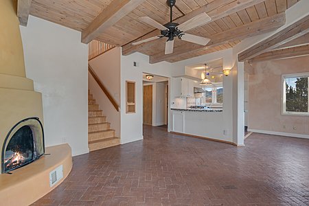 Beautiful Brick floor and Kiva Fireplace with Beam Ceiling in Great Room 