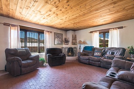 Living Room with Brick Flooring and view of Kiva Fireplace