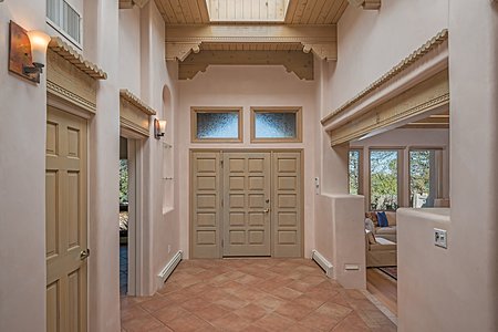Dramatic formal entry with 13' high beamed ceiling arched nicho, hand trowel plaster walls and 3 big skylights 