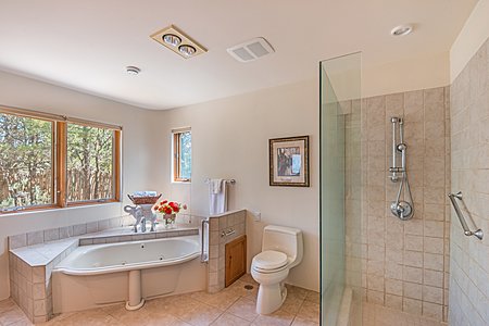Master Bathroom Kohler jetted tub and casement windows facing coyote-fenced side grounds