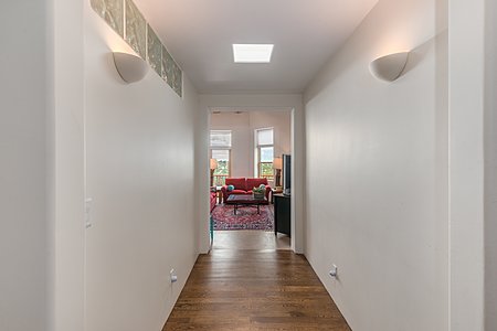 Sleek hallway to studio and second living room