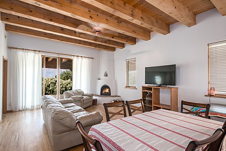Living room with wood burning kiva fireplace