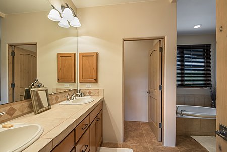 Double vanity in the master bathroom which has a tub and separate shower.