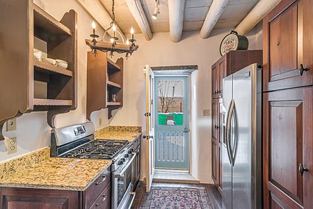 Natural gas stove, stainless steel appliances, and a handcarved screen door to the back yard...