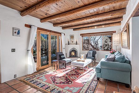 Living room, kiva fireplace, Saltillo tile, plaster walls, vigas.