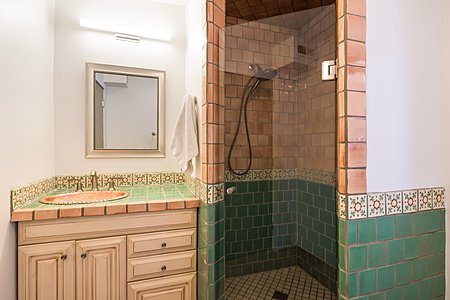 Guest bathroom has pretty handpainted tiles and shower!