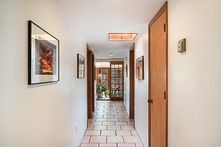 Art Displaying Long Central Hallway with view into Solarium 