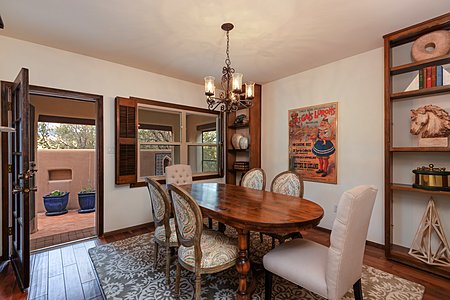 The Lovely Dining Room Has Built In Floor to Ceiling Shelves & Opens to a Rear Walled Patio 