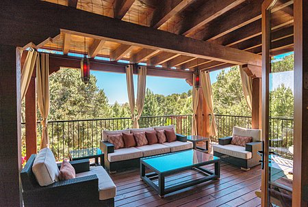 A breezy, handsome outdoor living room overlooks the gardens