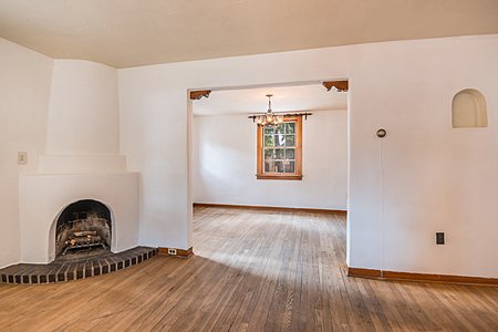 Kiva Fireplace in Living room with view into Dining room