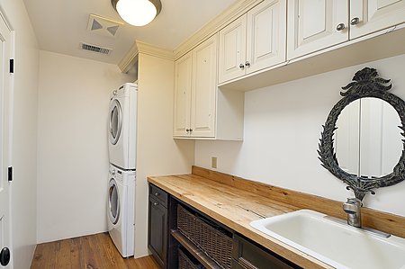 Laundry room with counter plus storage and utility sink