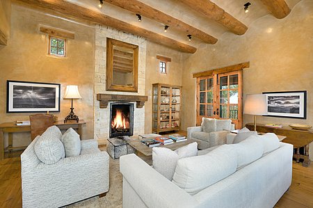 Living room with stone fireplace and terrace to the right