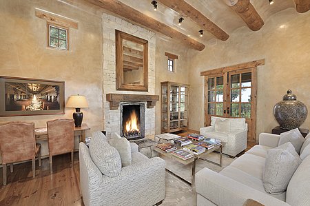 Living room with stone fireplace and terrace to the right
