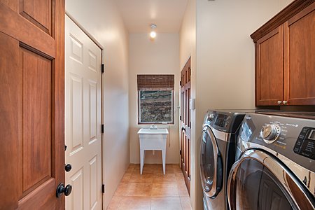Laundry Area with Utility Sink and easy access to the Three-Car Garage
