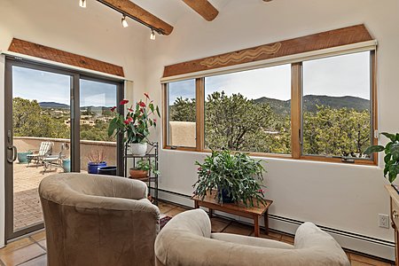 Sunroom with large picture windows to capture mountain views opens to a patio