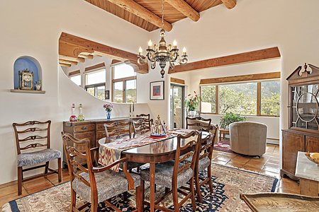 Dining room separated from the living room by a shepherd's fireplace opens to a sunroom
