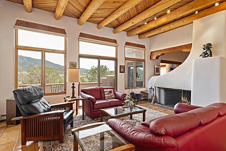 Living room with shepherd's fireplace and spectacular views to the mountains 