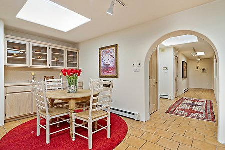 Informal dining area with arched passageway into main hallway