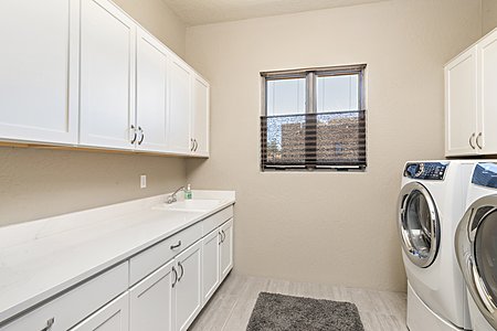 Laundry Room with Custom Cabinetry; Utility Sink; Electrolux Washer & Dryer
