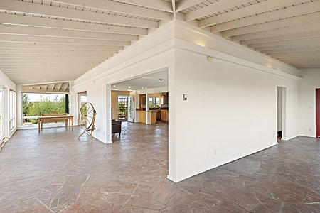 Gorgeous stone floors, surrounded by glass and views - the main house downstairs