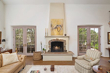 Living room fireplace flanked by French doors