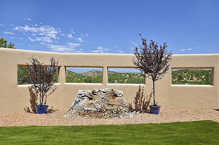 Wall in central courtyard with stone water feature and mountain views