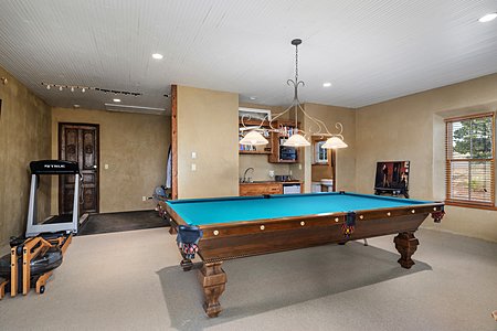 The carriage house is used as entertaining space with a full bathroom and two car garage
