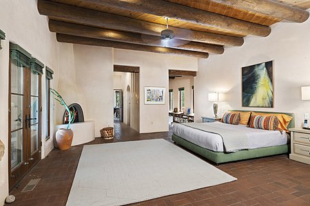 Spacious Master Bedroom w/ Dramatic Fireplace & French Doors leading to a Private Back Yard Portal