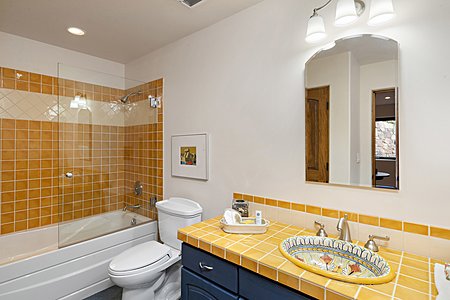 Guest bathroom with tub and cheery tiles!