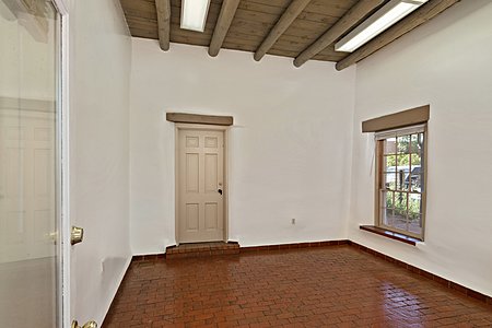 Gorgeous adobe walls,  rock floors, finished ceilings and access to the outside!