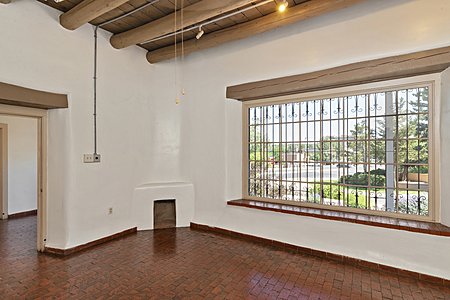 A picture window and a fireplace in this lovely, spacious, view office