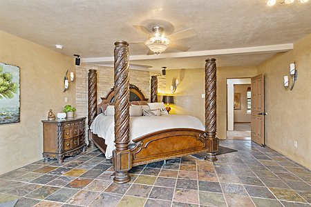 Master bedroom with stone wall