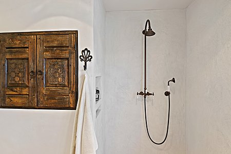 Master shower with cool hand carved cabinet