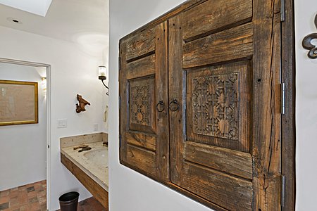 A cool hand carved cabinet In master bath